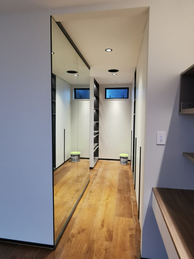 This corridor mirror wall is just outside of the bathroom in a master bedroom. It provides more light, convenience and modern element to the home users. We have used the gym mirror installation technique to ensure the mirrors in safe condition and durability.
