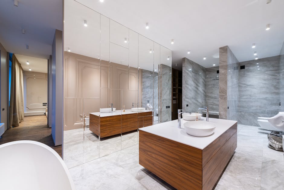 Interior of stylish spacious bathroom with mirrored wall placed in modern luxury apartment